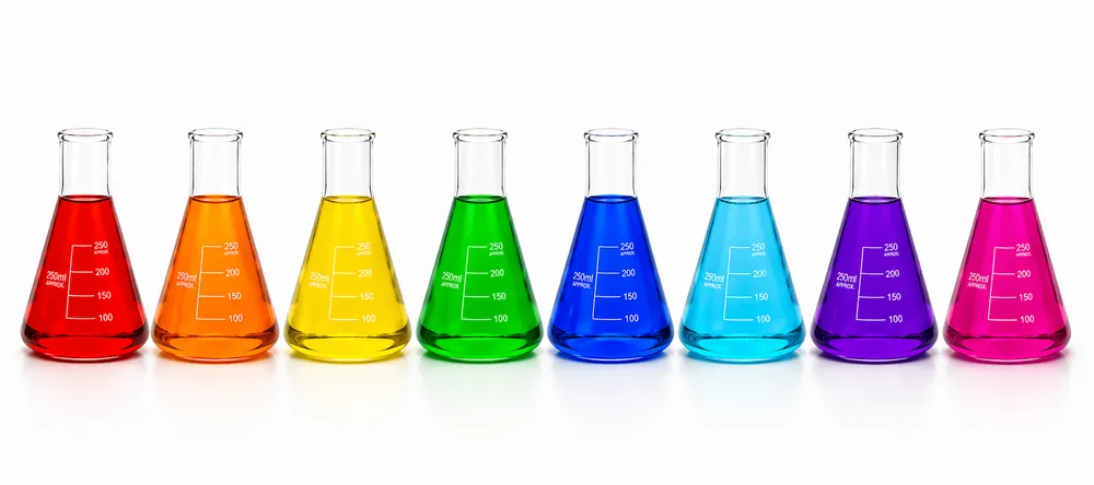Laboratory glassware with colored chemical solutions